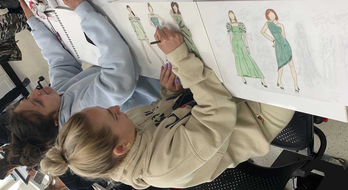 students sketching in a classroom