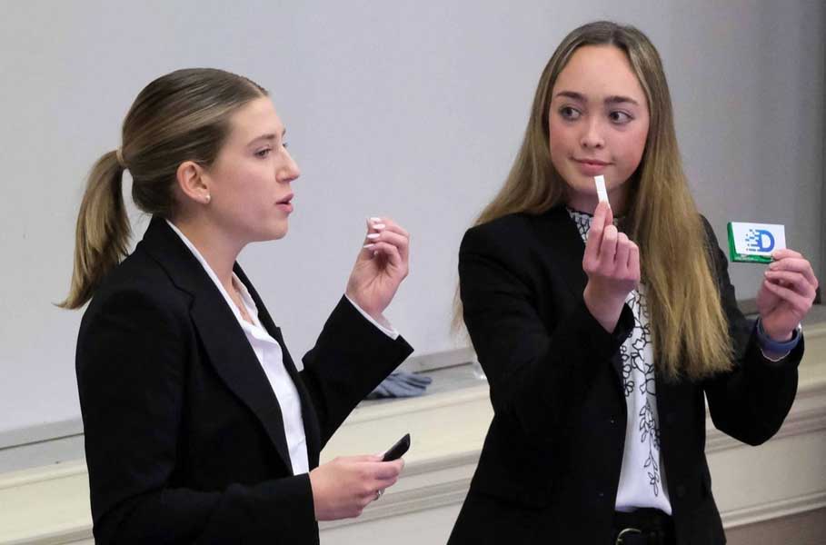 close up view of Amanda Simeone and team member presenting in a classroom